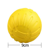 Yellow rubber Dog Molar Chew Toy Durable Ball with measurement text on a white background
