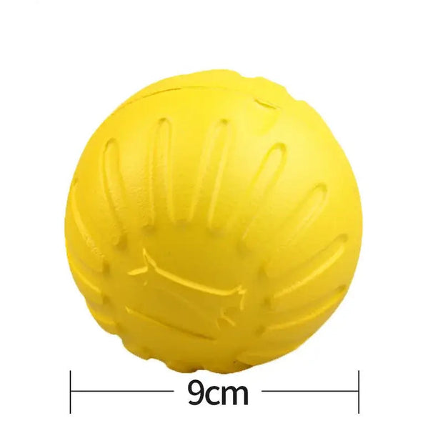 Yellow rubber Dog Molar Chew Toy Durable Ball with measurement text on a white background