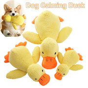 Dog Calming Duck Plush Toy with a dog holding it, on a white background