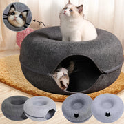 Felt Cat Cave Bed with two cats inside, one peeking out, on a wooden floor.