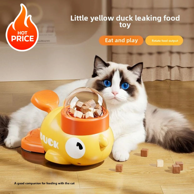 Cat playing with a Little Yellow Duck Pet Feeder toy that leaks food