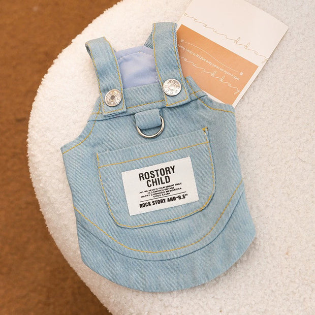 Cute Pet Overalls Dress Denim and Plaid Style for a child on a textured surface with a label.