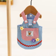 Children's Cute Pet Overalls Dress Denim and Plaid Style apron with red checkered straps on a wooden hanger against a white background