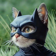 Cat in a black Pet Avengers Mask Set with green grass in the background