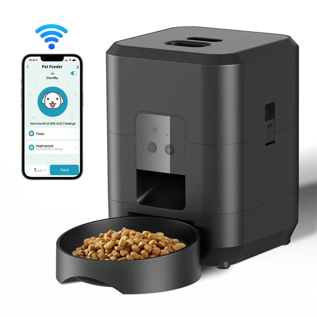 Black Smart Automatic Pet Feeder with WiFi Control with a bowl of kibble and a smartphone displaying a pet feeding app on a white background.