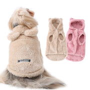 Dog wearing a Plush Winter Vest  with two additional coats in beige and pink on a white background.