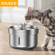 Cat drinking water from a ROJECO 304 Stainless Steel Smart Pet Water Fountain on a wooden floor.