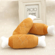 Plush Slipper Dog Toy resembling a chicken drumstick on a textured surface with a 'Photo Form' frame in the background.