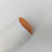 Roll of white paper of Cigar Dog Toy with a brown end on a light gray background
