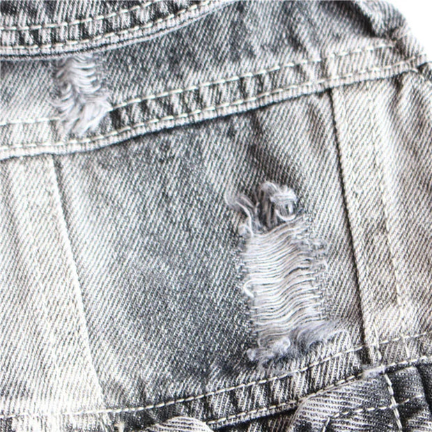 Close-up of a distressed Cool Dog Jeans Jacket with frayed edges.