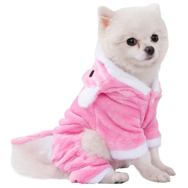 Small dog wearing a pink Dinosaur Hoodie Costume with white trim on a white background