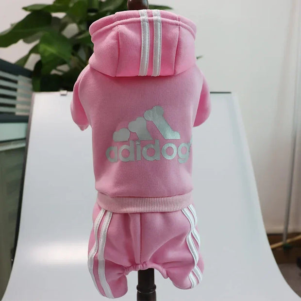 Pink dog Adidog Hoodie with Adidas logo on a white chair