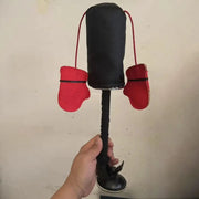 Black and red Cat Boxing Training Toy held by a hand against a plain background