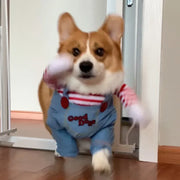 Corgi dog wearing a Killer Doll Pet Costume with 'Good Dog' overalls indoors.