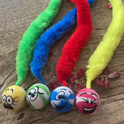 Colorful Rainbow Tail Cat Toy Balls ends and cartoon face balls on a wooden surface
