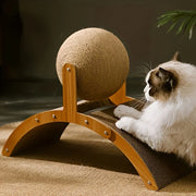 Cat playing with a Cat Scratcher with Sisal Ball post on a wooden platform.
