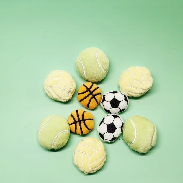 Collection of sports Soft Plush Pet Sports Balls Toy Set on a green background