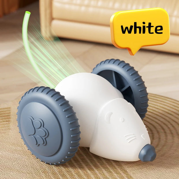 White and gray Smart Interactive Cat Toy mouse with green light on a wooden surface, labeled 'white'.