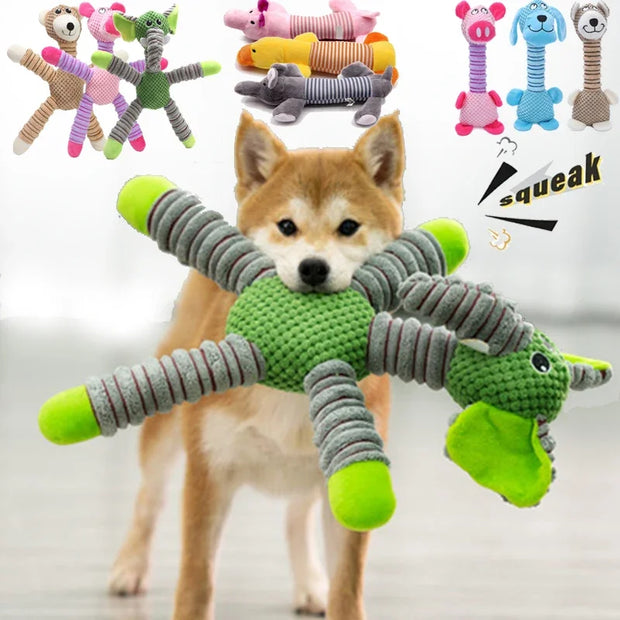 Dog holding a green and gray Plush Animal Dog Toys with other similar toys in the background.