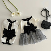 Pet Elegant Black Bow Dress and a small black handbag on a light background