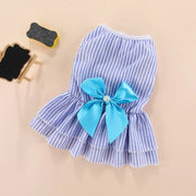 Blue and white Summer Princess Dress with a large blue bow on a beige background
