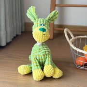 Green and yellow knitted Plush Animal Rope Dog Toys on a wooden floor with a basket in the background.