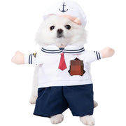 Small dog wearing a Halloween Bat Skeleton Costume with a white hat, red tie, and navy shorts on a white background.