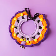 Halloween Knitted Collar Pet knitted wreath with pom-poms on a purple background
