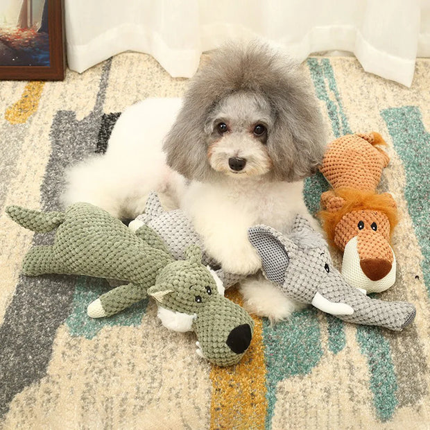 Dog sitting on a patterned rug with stuffed Plush Animal Dog Toys
