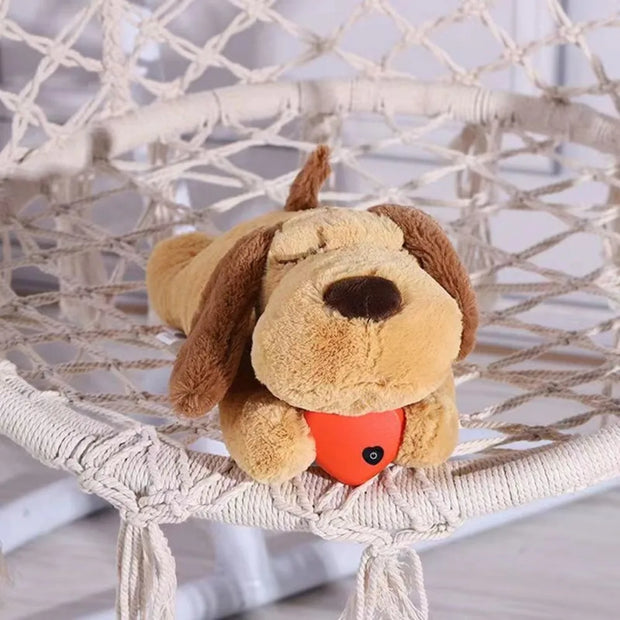 Heartbeat Plush Dog Toy with a red ball on a white hammock