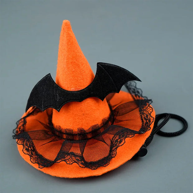 Orange Halloween Witch Hat Collection with black lace and bat wings on a gray background