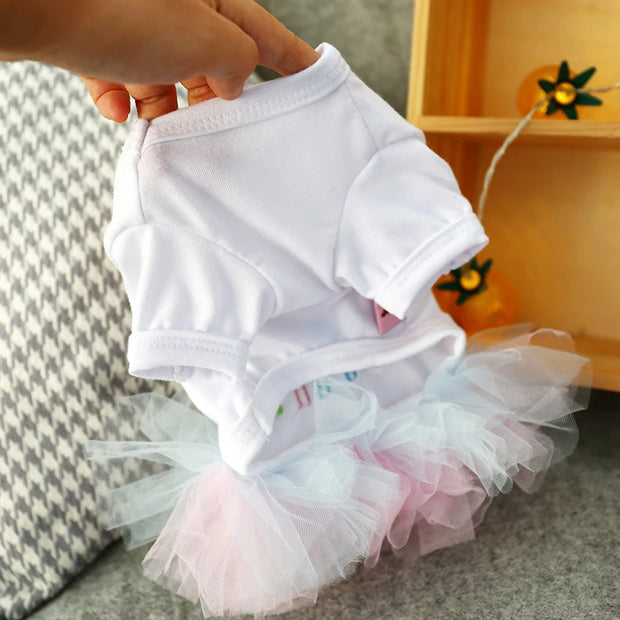 White pet Birthday Tutu Dress, held by a hand on a neutral background.