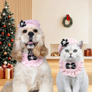 Two pet wearing pink Elegant Cat Costume Set in a festive room with Christmas tree and wreath.