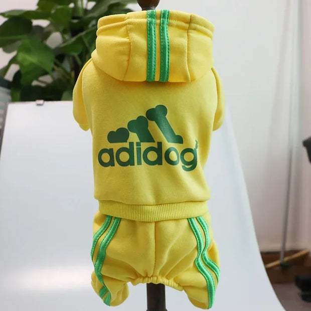Yellow dog Adidog Hoodie and shorts set with green accents on a mannequin, branded 'adidog'.