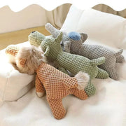 Three knitted Plush Animal Dog Toys on a soft surface