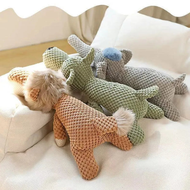 Three knitted Plush Animal Dog Toys on a soft surface