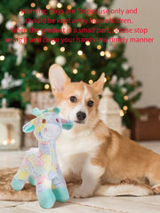 Dog with a Plush Giraffe Dog Toy in front of a Christmas tree