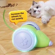 Green Smart Interactive Cat Toy with wheels on a wooden floor next to a cat