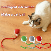 Cat playing with Automatic Moving with LED Light Cat Toy Ball on a wooden floor, with text 'Intelligent interaction Make a cat ball'.