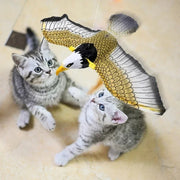 Two kittens playing with a Electric Flying Bird Cat Toy on a light-colored surface