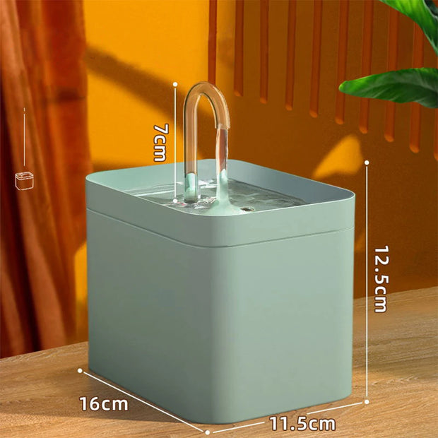 Green Modern Pet Water Fountain  with dimensions on a wooden surface and orange curtain background