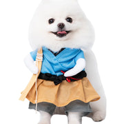 White dog wearing Halloween Bat Skeleton Costume a blue robe and yellow skirt with a white background