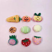 Set of colorful fruit-shaped Soft Plush Pet Sports Balls Toy Set on a pink background