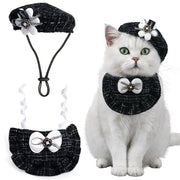 Cat wearing a black and white decorative Elegant Cat Costume Set, sitting on a white background.