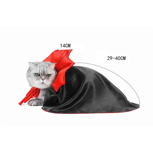 Cat wearing a black Vampire Cape Costume with red accents, measurement details shown.