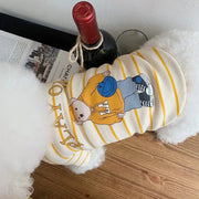 Wine bottle with a dog that wear Striped Bear T-Shirt a cartoon character on a wooden surface.