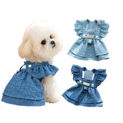 Dog wearing a blue Denim Dog Dress with ruffles and buttons, displayed on a white background.