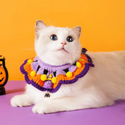 White cat wearing a colorful Halloween Knitted Collar on a purple and orange background