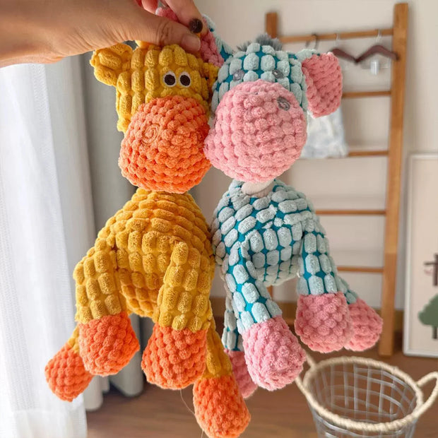 Two colorful Plush Animal Rope Dog Toys, one orange and yellow, the other pink and blue, held by a hand.
