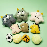 Soft Plush Pet Sports Balls Toy Set resembling monsters and animals on a green background